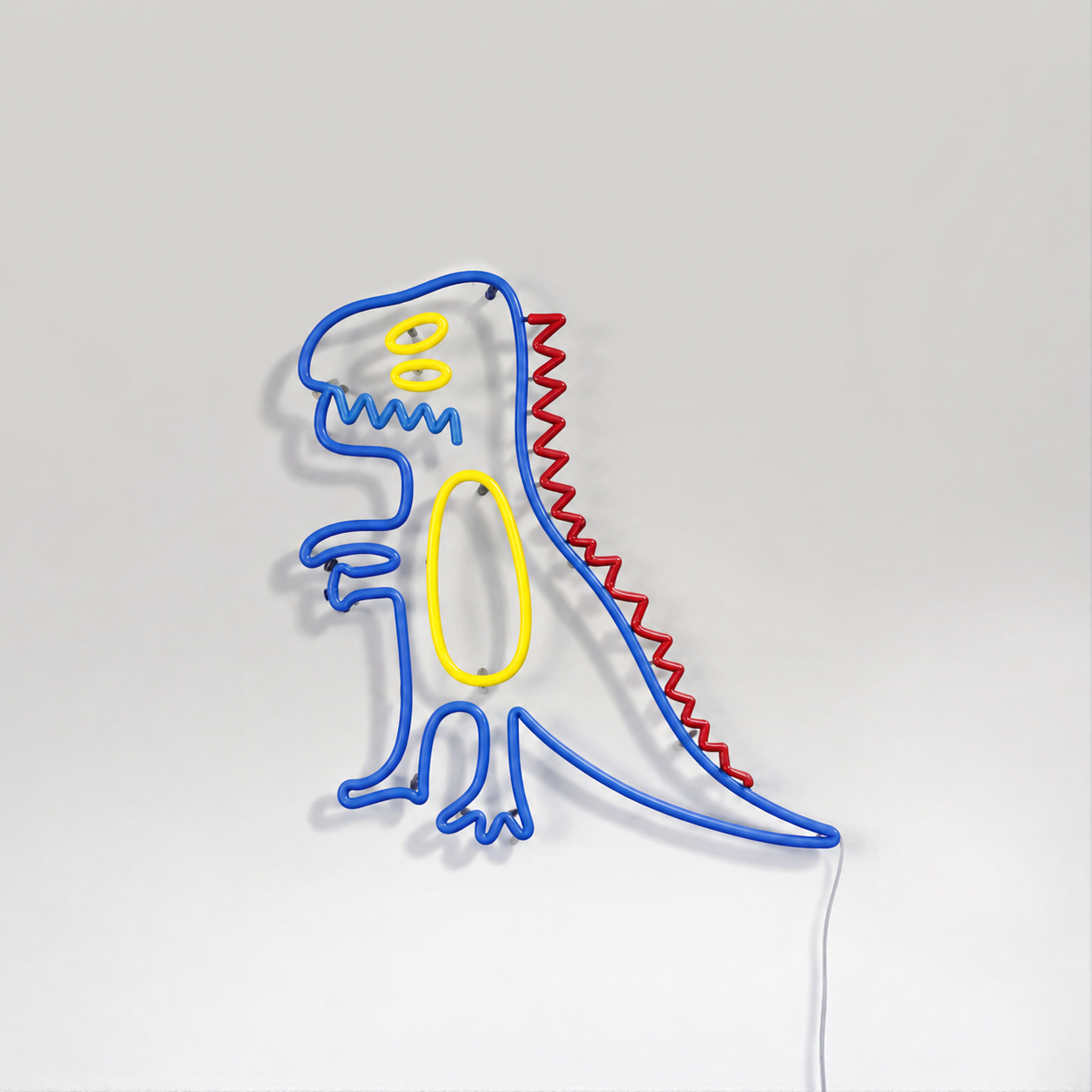 Néon LED Big T-Rex Kid en forme de dinosaure dessiné, bleu jaune rouge, sur mur blanc